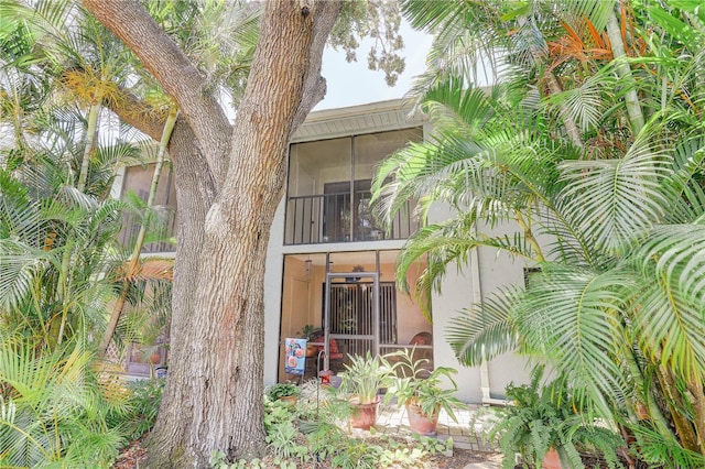 11800 Park Blvd Unit 208, Seminole, FL 33772 - back of house featuring stucco siding and a sunroom