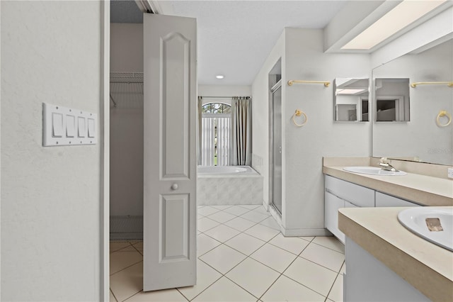 206 Forest Wood Ct, Spring Hill, FL 34609 - full bathroom with vanity, a bath, a shower stall, tile patterned flooring, and a walk in closet