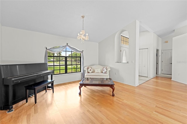 206 Forest Wood Ct, Spring Hill, FL 34609 - living area featuring wood finished floors, a chandelier, and vaulted ceiling