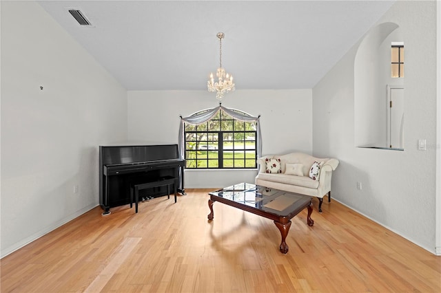 206 Forest Wood Ct, Spring Hill, FL 34609 - living area with wood finished floors, a chandelier, baseboards, and arched walkways
