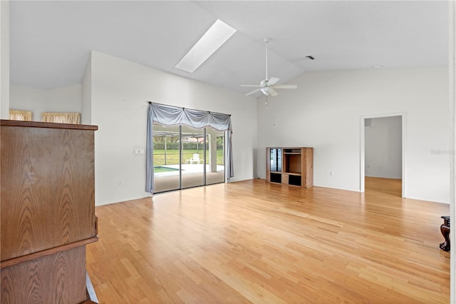 206 Forest Wood Ct, Spring Hill, FL 34609 - unfurnished living room with a ceiling fan, a skylight, high vaulted ceiling, and light wood-type flooring