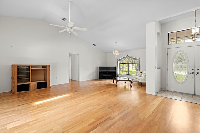 206 Forest Wood Ct, Spring Hill, FL 34609 - entryway with a chandelier, high vaulted ceiling, light wood finished floors, arched walkways, and ceiling fan