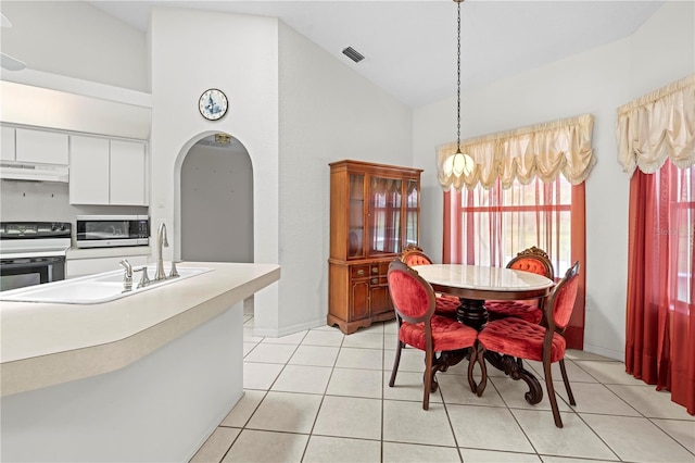 206 Forest Wood Ct, Spring Hill, FL 34609 - dining area with arched walkways, vaulted ceiling, a chandelier, and light tile patterned floors