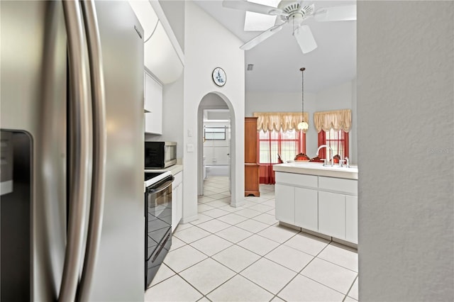 206 Forest Wood Ct, Spring Hill, FL 34609 - kitchen with stainless steel appliances, white cabinets, light countertops, a ceiling fan, and lofted ceiling