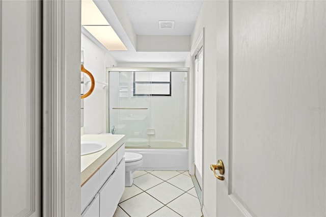 206 Forest Wood Ct, Spring Hill, FL 34609 - full bathroom with toilet, vanity, tile patterned floors, enclosed tub / shower combo, and a textured ceiling