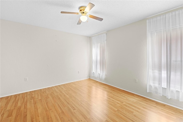 206 Forest Wood Ct, Spring Hill, FL 34609 - unfurnished room with light wood-type flooring, ceiling fan, a textured ceiling, and baseboards