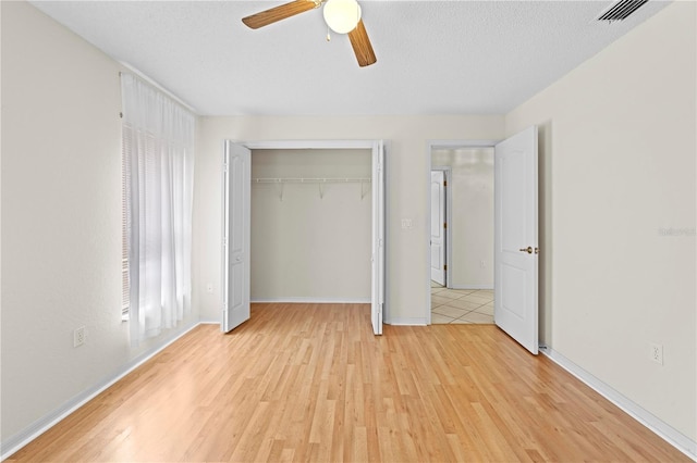 206 Forest Wood Ct, Spring Hill, FL 34609 - unfurnished bedroom featuring light wood-style flooring, a closet, a ceiling fan, and baseboards