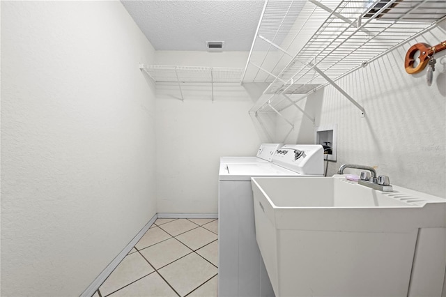 206 Forest Wood Ct, Spring Hill, FL 34609 - washroom featuring washing machine and dryer, baseboards, light tile patterned floors, and a textured ceiling