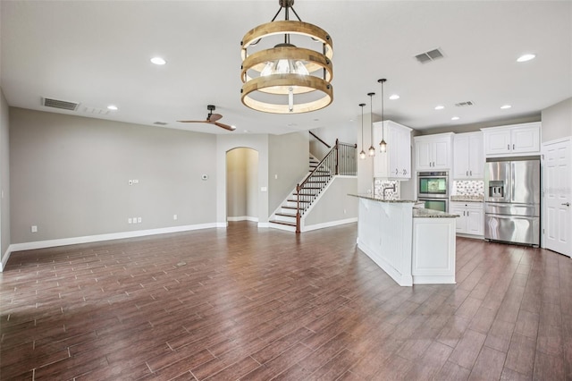 19711 Wellington Manor Blvd, Lutz, FL 33549 - kitchen with stainless steel appliances, arched walkways, pendant lighting, dark wood-style floors, and recessed lighting
