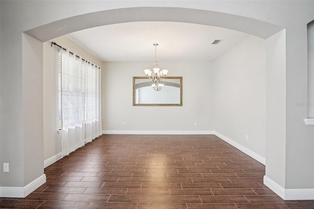 19711 Wellington Manor Blvd, Lutz, FL 33549 - spare room featuring wood tiled floors, arched walkways, and a chandelier