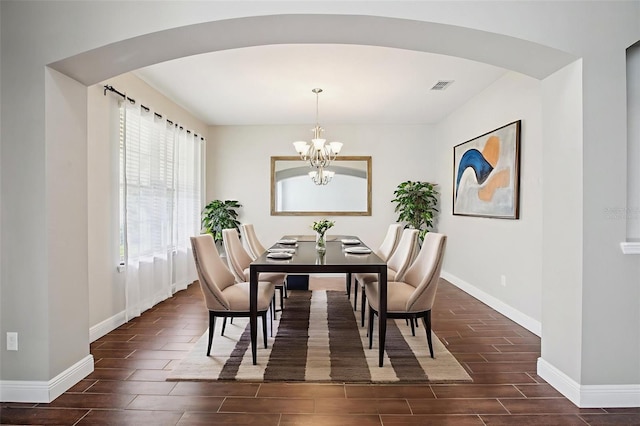 19711 Wellington Manor Blvd, Lutz, FL 33549 - dining area featuring arched walkways, wood finish floors, and a chandelier