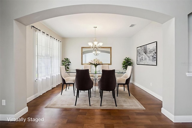 19711 Wellington Manor Blvd, Lutz, FL 33549 - dining room with arched walkways, wood finished floors, and a chandelier