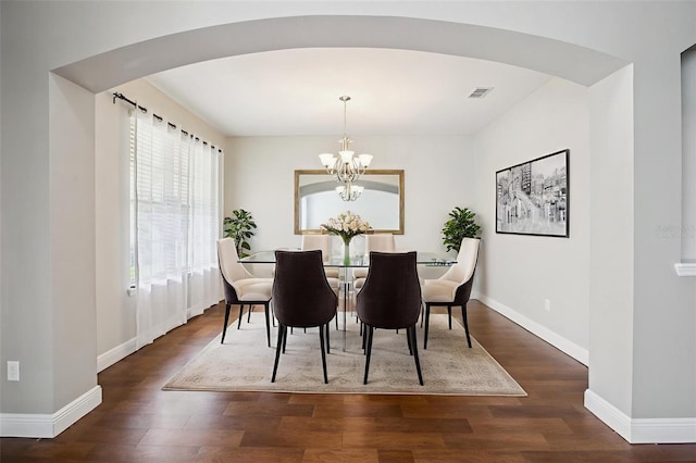 19711 Wellington Manor Blvd, Lutz, FL 33549 - dining room with arched walkways, wood finished floors, and a chandelier