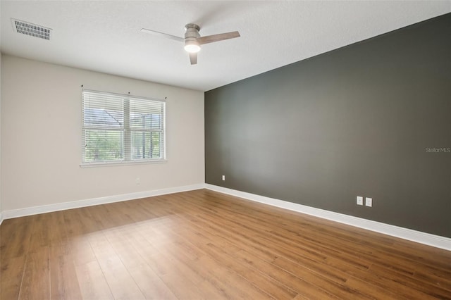 19711 Wellington Manor Blvd, Lutz, FL 33549 - unfurnished room featuring ceiling fan and wood finished floors