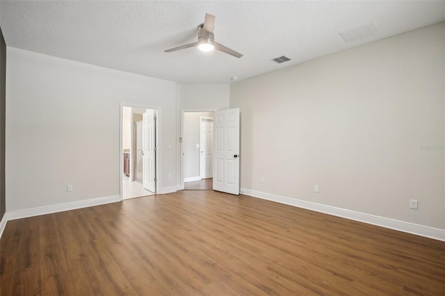 19711 Wellington Manor Blvd, Lutz, FL 33549 - unfurnished bedroom with wood finished floors, ensuite bathroom, and a ceiling fan