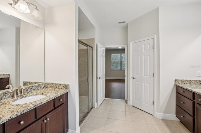 19711 Wellington Manor Blvd, Lutz, FL 33549 - bathroom with two vanities, a stall shower, and tile patterned floors