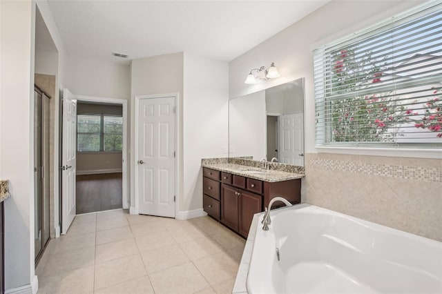 19711 Wellington Manor Blvd, Lutz, FL 33549 - full bathroom with vanity, a bath, a shower stall, and tile patterned floors