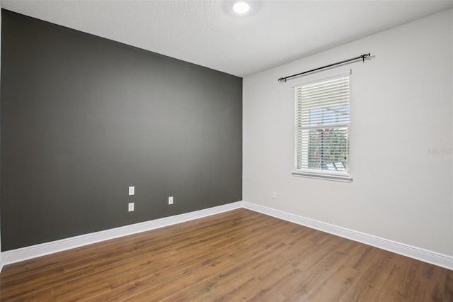 19711 Wellington Manor Blvd, Lutz, FL 33549 - unfurnished room featuring wood finished floors and baseboards