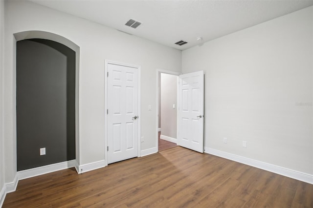19711 Wellington Manor Blvd, Lutz, FL 33549 - unfurnished bedroom with wood finished floors and arched walkways