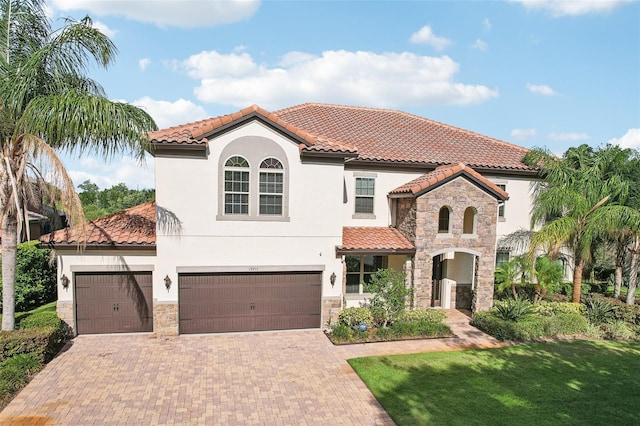 19711 Wellington Manor Blvd, Lutz, FL 33549 - mediterranean / spanish house featuring stone siding, stucco siding, and a tiled roof