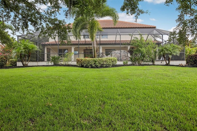 19711 Wellington Manor Blvd, Lutz, FL 33549 - back of house with a tile roof, a yard, stucco siding, and a lanai
