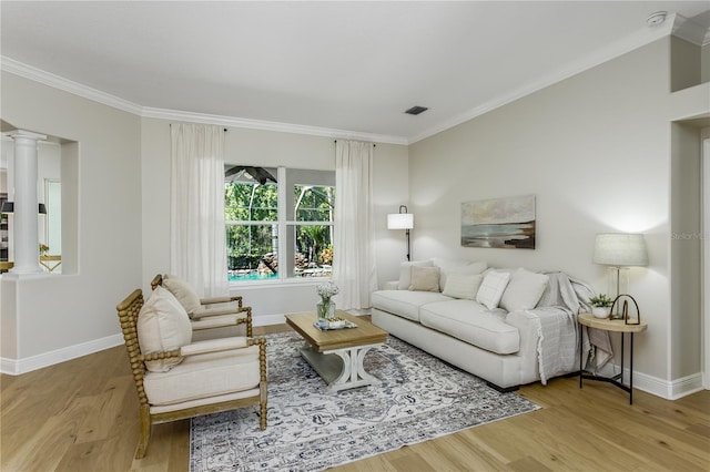 11938 Royce Waterford Cir, Tampa, FL 33626 - living area featuring ornamental molding, decorative columns, baseboards, and wood finished floors