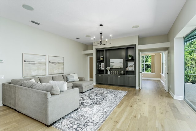 11938 Royce Waterford Cir, Tampa, FL 33626 - living area with a chandelier, light wood-style flooring, and baseboards