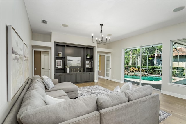 11938 Royce Waterford Cir, Tampa, FL 33626 - living room with plenty of natural light, a chandelier, and baseboards