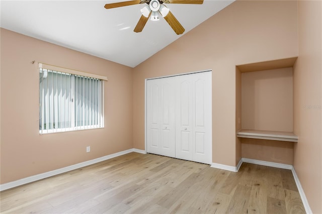 11938 Royce Waterford Cir, Tampa, FL 33626 - unfurnished bedroom featuring wood finished floors, baseboards, a closet, ceiling fan, and high vaulted ceiling