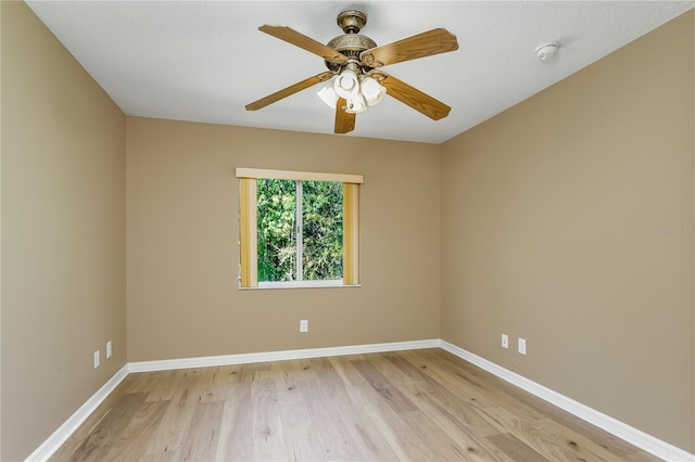 11938 Royce Waterford Cir, Tampa, FL 33626 - spare room with light wood finished floors, baseboards, a ceiling fan, and a smoke detector