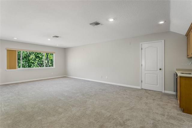 11938 Royce Waterford Cir, Tampa, FL 33626 - spare room featuring light carpet, baseboards, recessed lighting, and a sink