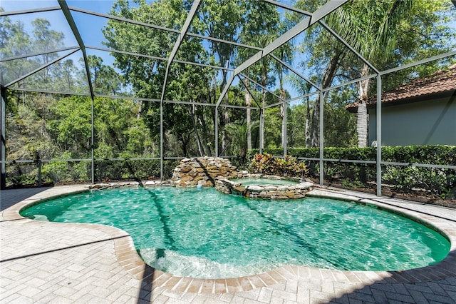 11938 Royce Waterford Cir, Tampa, FL 33626 - view of swimming pool with a pool with connected hot tub, glass enclosure, and a patio