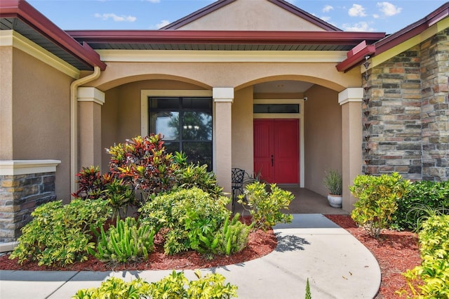 4608 Scott Rd, Lutz, FL 33558 - entrance to property with stucco siding, stone siding, and a porch