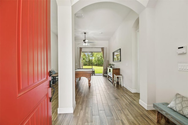 4608 Scott Rd, Lutz, FL 33558 - foyer entrance featuring arched walkways, pool table, baseboards, and wood finished floors