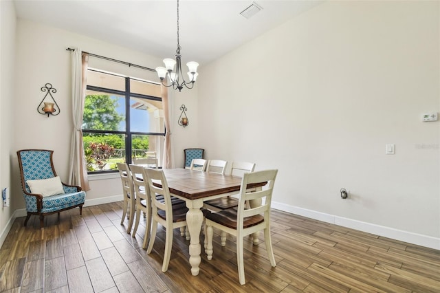 4608 Scott Rd, Lutz, FL 33558 - dining space featuring wood finished floors, a chandelier, and baseboards