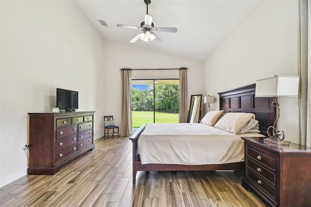 4608 Scott Rd, Lutz, FL 33558 - bedroom featuring access to exterior, wood finished floors, high vaulted ceiling, baseboards, and a ceiling fan