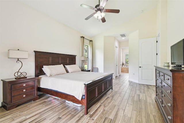 4608 Scott Rd, Lutz, FL 33558 - bedroom with light wood finished floors, vaulted ceiling, ensuite bath, and ceiling fan