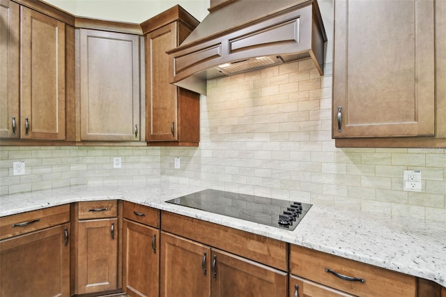 4608 Scott Rd, Lutz, FL 33558 - kitchen with black electric cooktop, custom range hood, and decorative backsplash