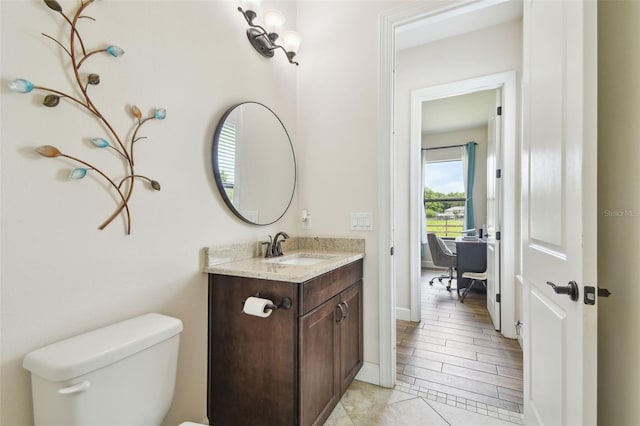 4608 Scott Rd, Lutz, FL 33558 - half bathroom with toilet, vanity, and baseboards