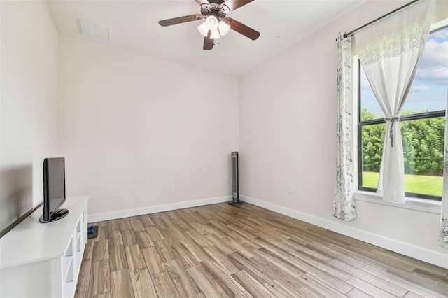4608 Scott Rd, Lutz, FL 33558 - unfurnished room with light wood-style floors, ceiling fan, and baseboards