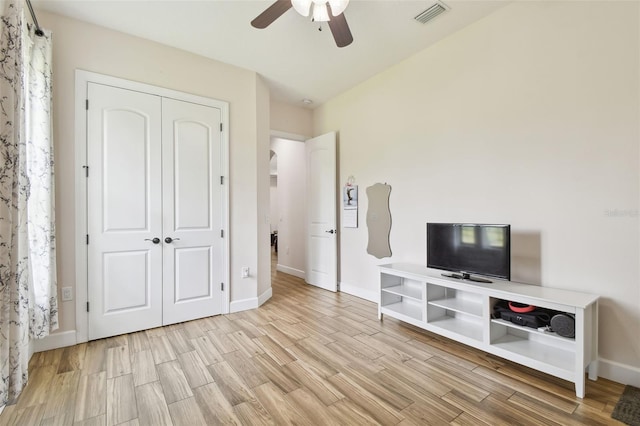 4608 Scott Rd, Lutz, FL 33558 - unfurnished living room with a ceiling fan, light wood-type flooring, and baseboards