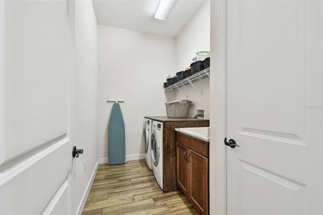 4608 Scott Rd, Lutz, FL 33558 - laundry area featuring washing machine and dryer, light wood-style floors, and baseboards