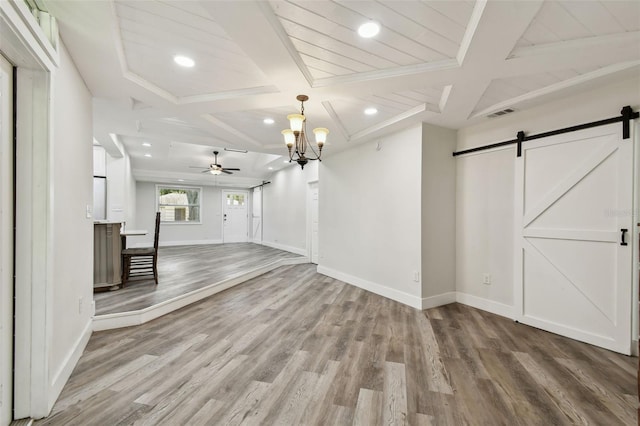 816 9th Ave SW, Largo, FL 33770 - unfurnished living room with a barn door, coffered ceiling, ceiling fan, wood finished floors, and baseboards