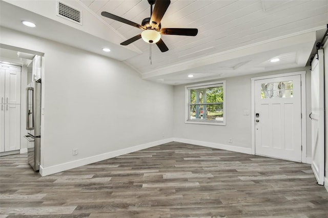 816 9th Ave SW, Largo, FL 33770 - entryway with vaulted ceiling, a barn door, recessed lighting, baseboards, and wood finished floors