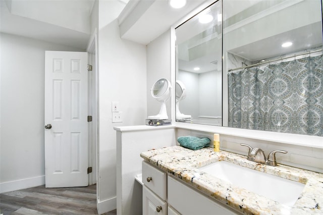 816 9th Ave SW, Largo, FL 33770 - bathroom featuring vanity, wood finished floors, baseboards, curtained shower, and recessed lighting