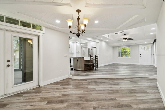816 9th Ave SW, Largo, FL 33770 - unfurnished living room with baseboards, wood finished floors, recessed lighting, a chandelier, and a ceiling fan
