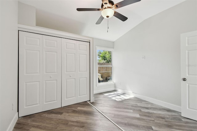 816 9th Ave SW, Largo, FL 33770 - unfurnished bedroom featuring lofted ceiling, baseboards, a closet, wood finished floors, and a ceiling fan