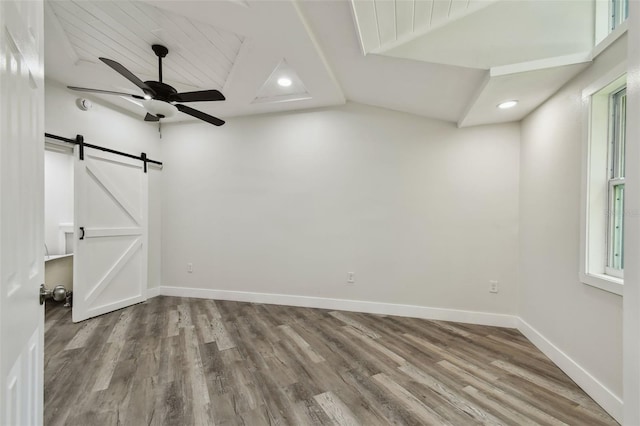 816 9th Ave SW, Largo, FL 33770 - empty room with a barn door, wood finished floors, ceiling fan, baseboards, and recessed lighting