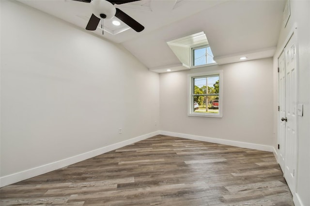 816 9th Ave SW, Largo, FL 33770 - unfurnished bedroom with a closet, baseboards, wood finished floors, vaulted ceiling, and recessed lighting