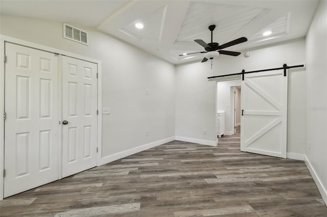 816 9th Ave SW, Largo, FL 33770 - empty room featuring ceiling fan, a barn door, wood finished floors, baseboards, and recessed lighting